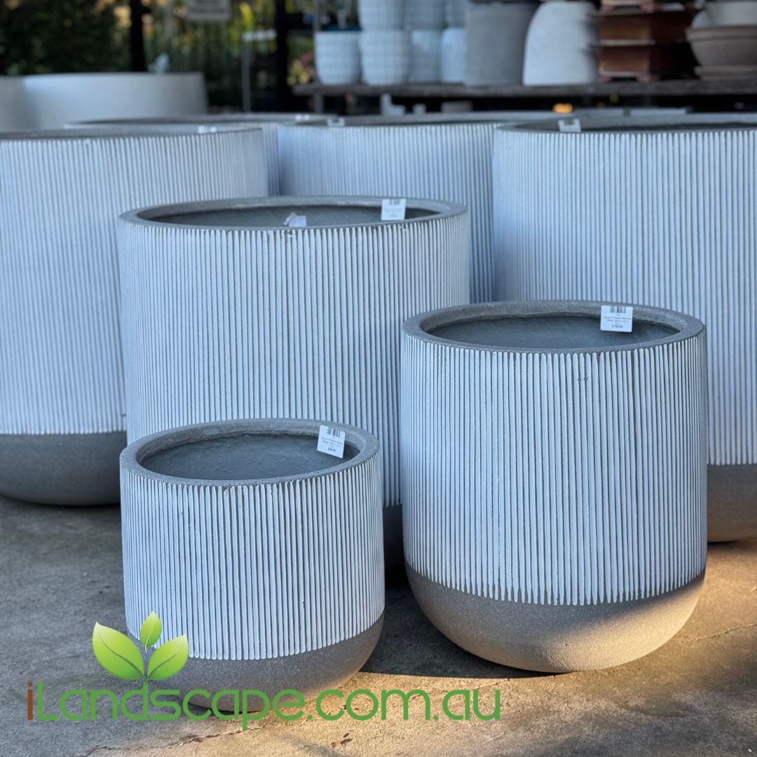 Set of gray cylindrical planters with ribbed texture on a concrete surface, brand 'landscape.com.au' visible.