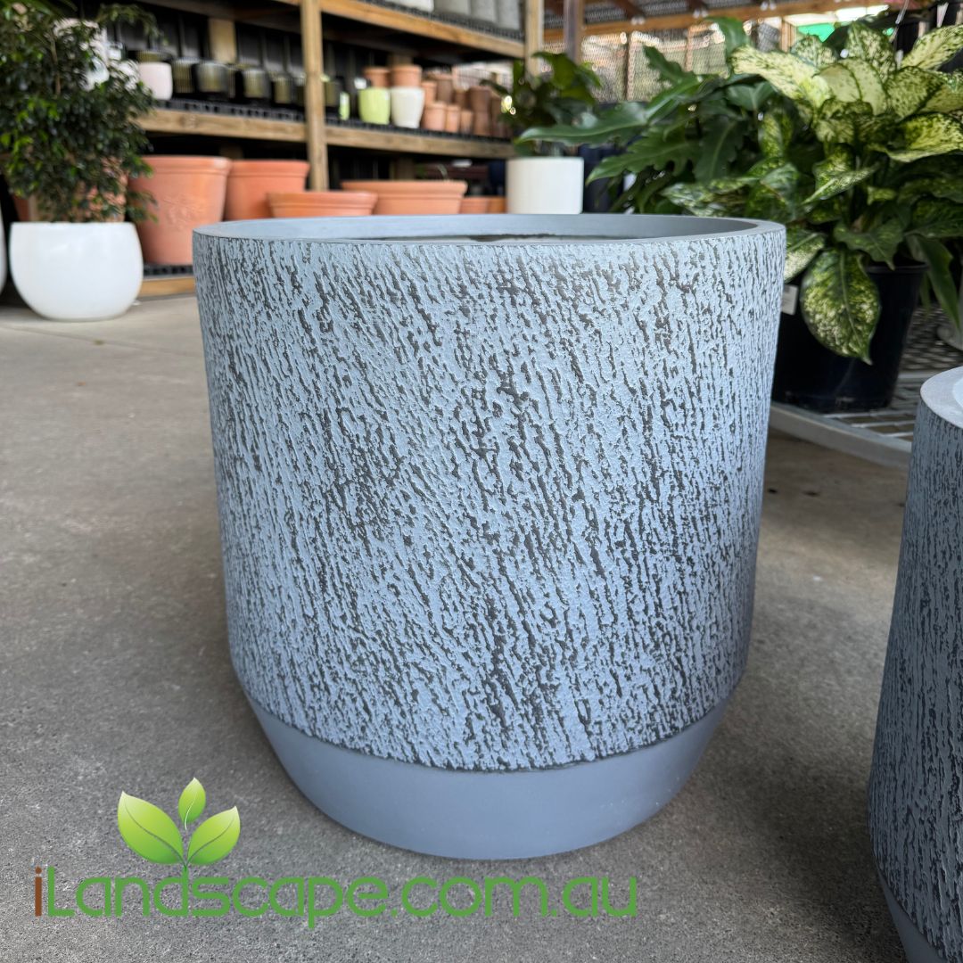 Textured gray pot on a concrete floor with 'Landscape.com.au' logo.