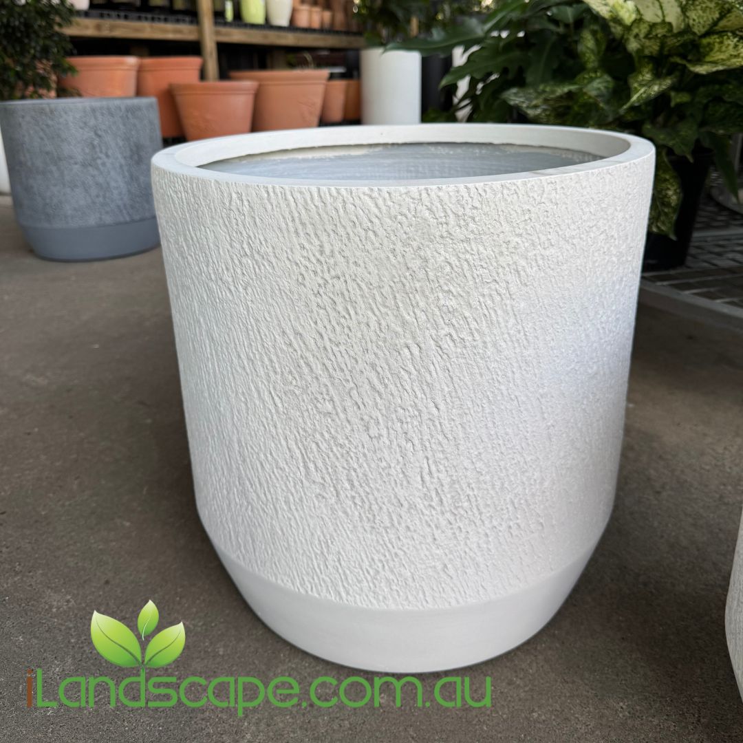 Textured white planter on a concrete surface with 'Landscape.com.au' logo.