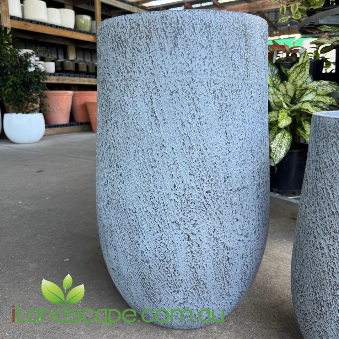 Textured gray planter in a garden setting with 'Landscape.com.au' branding.