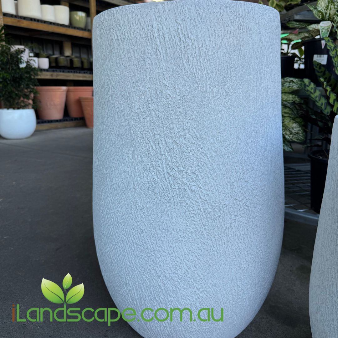Textured  planter in a garden center setting with 'iLandscape.com.au' branding.